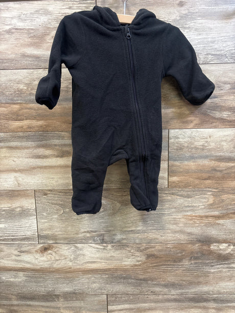 Front view of Wonder Nation black fleece bunting showcasing full-length zipper and hood with wood-look floor background