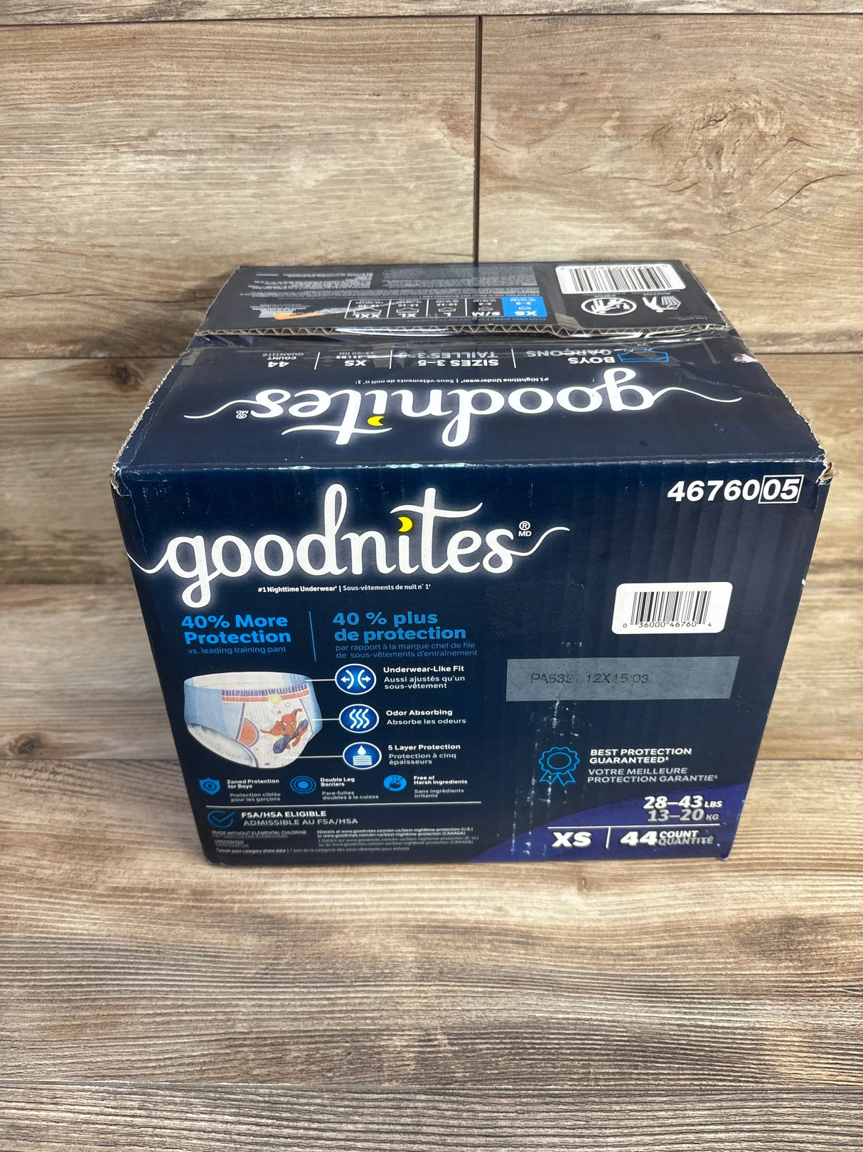 Front view of Goodnites Marvel nighttime underwear box (44 ct, XS 28-43 lb) showing '40% More Protection' text on wood background
