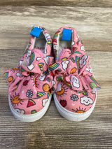 Top-front view of Limited Too pink slip-on sneakers size 8C showing fabric bows, sun and rainbow print, white rubber soles on wood