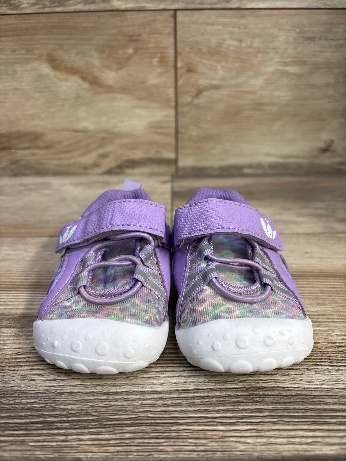 Front view of FEETCITY barefoot water shoes, purple size 4/5C, showing bungee laces, velcro strap, white textured toe on wood