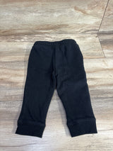 Black toddler pants with elastic waistband on wood surface