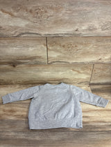 Gray toddler long sleeve sweatshirt laid flat on wood floor, kids clothing resale