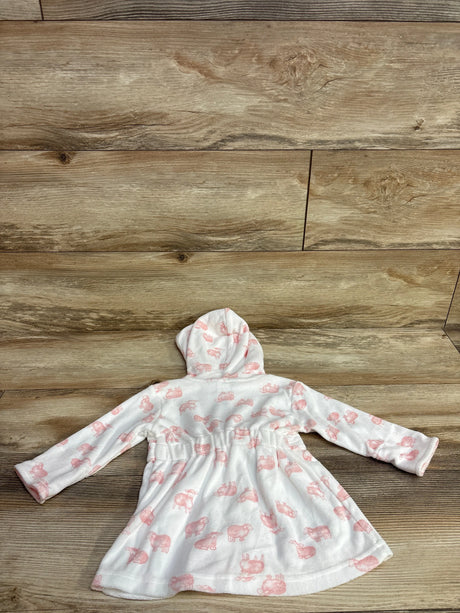 White baby hoodie dress with pink animal prints laid flat on wooden floor