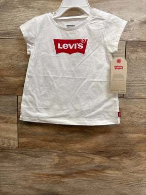 Front view of white toddler Levi's short-sleeve t-shirt showing red Levi's logo and attached retail tag on wooden floor background