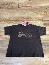 Black kids Barbie t-shirt with rhinestone logo, laid flat on wooden surface