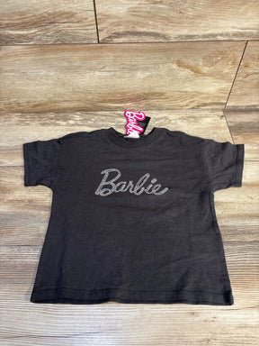 Black kids Barbie t-shirt with rhinestone logo, laid flat on wooden surface