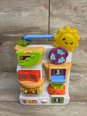 Front view of Fisher-Price Peek & Play Busy Garden with smiling sun gear, flip panels, numbered drawers and spinning drum