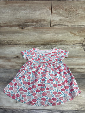 Flat lay of toddler floral dress by Touched By Nature showing pink rose print and gathered waist on wood plank background