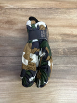 Pair of camouflage patterned winter mittens with elastic wrists on wooden surface