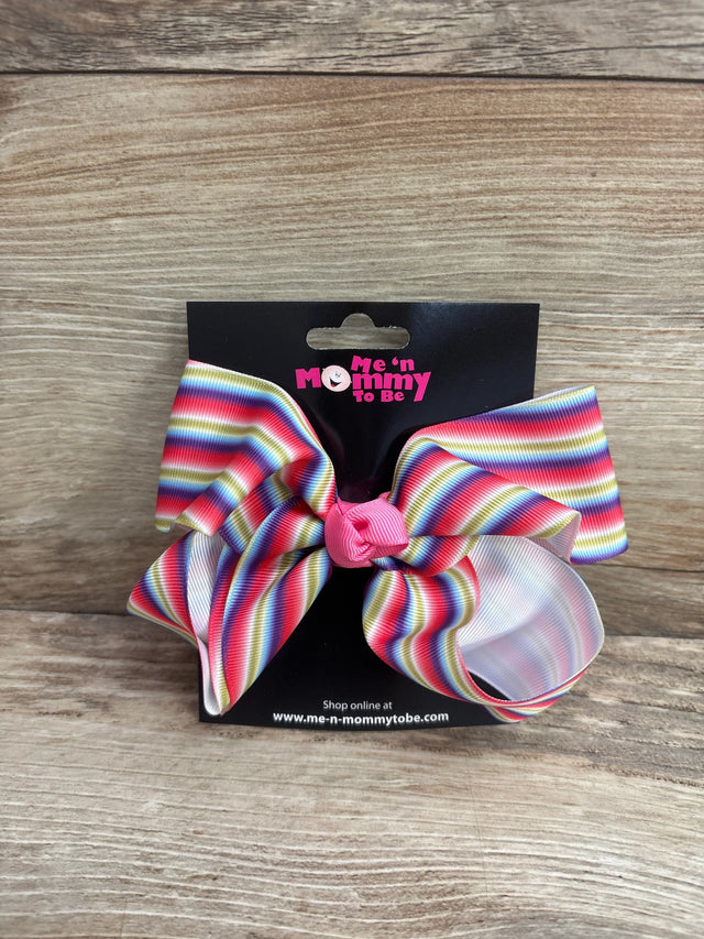 Front view of large striped rainbow hair bow with pink center knot on black Me n Mommy To Be display card on wood background