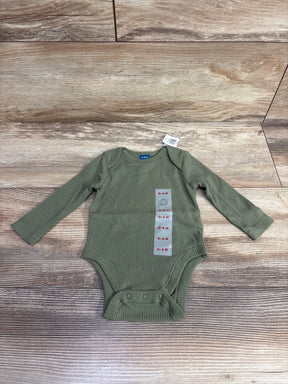 Olive green ribbed long sleeve baby bodysuit, size 0-3 months, on wooden background