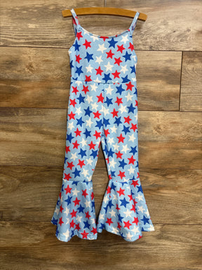 Front view of toddler bell-bottom jumpsuit with light blue fabric, red, white and blue star print and flared ruffle legs on wood background