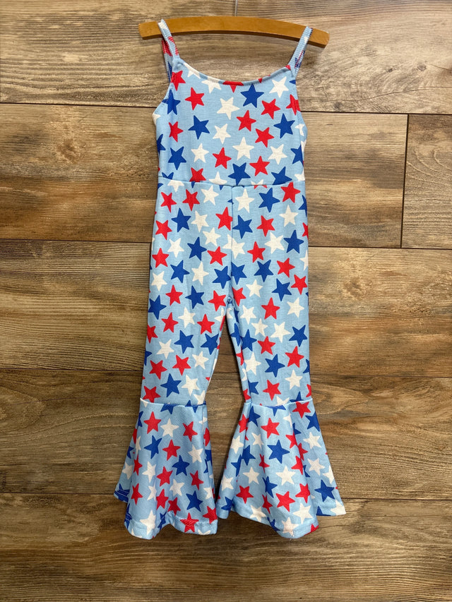 Front view of toddler bell-bottom jumpsuit with light blue fabric, red, white and blue star print and flared ruffle legs on wood background