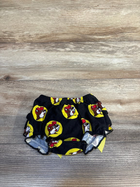 Black baby bloomers with cartoon dog face print and yellow circles on wood background