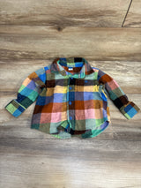 Multicolor plaid baby boy long sleeve shirt on wooden background