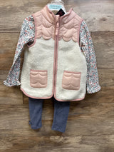 Front view of Cynthia Rowley 3-piece toddler set showcasing pink sherpa vest, floral shirt, and ribbed pants on wood