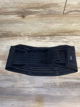 Black adjustable maternity support belt on wood floor, postpartum belly band
