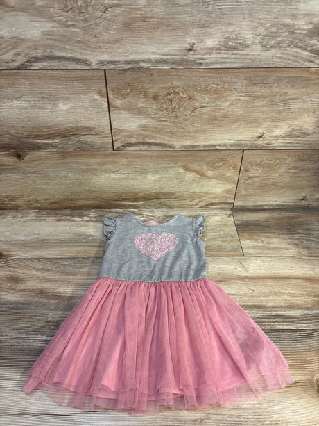 Gray and pink toddler dress with heart design and tulle skirt on wooden background