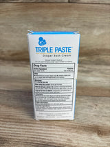 Back view of Triple Paste diaper rash cream 2 oz box showing brand logo and drug facts panel on a wooden surface