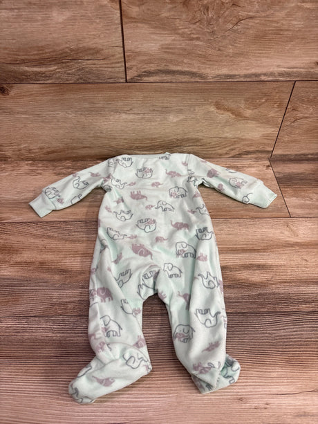 Top-down view of a mint green blanket sleeper with long sleeves, covered feet, and elephant print on a wood floor