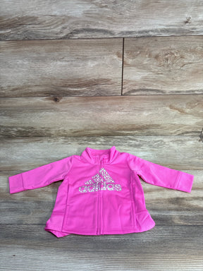 Pink Adidas toddler jacket with leopard print logo on wood background
