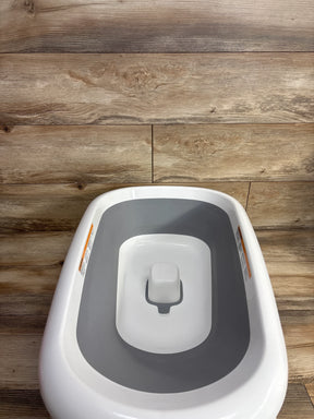 Gray and white baby potty training seat on wood floor