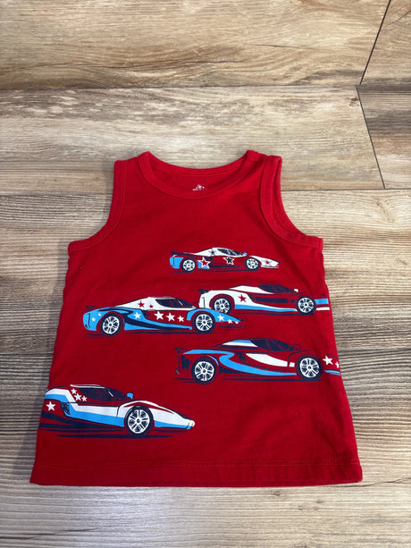 Flat lay of red toddler tank top showcasing blue-and-white patriotic racing car and star prints on wood floor