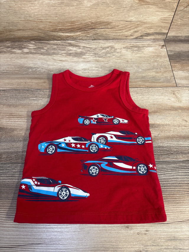 Flat lay of red toddler tank top showcasing blue-and-white patriotic racing car and star prints on wood floor