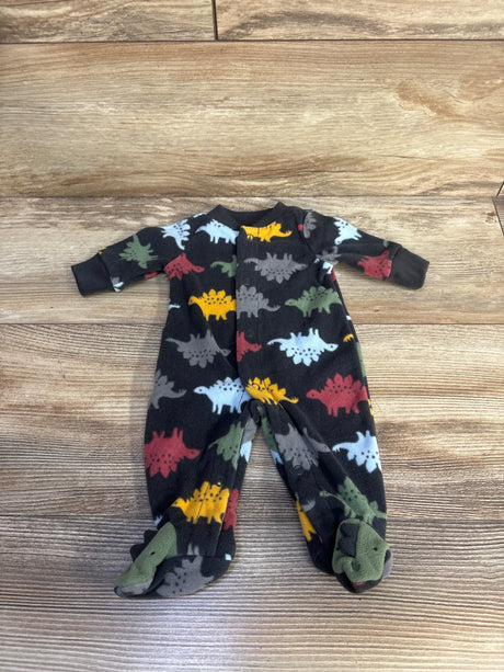 Flat lay of preemie Child Of Mine fleece sleeper with multicolor dinosaur print, footed with front snaps on wood background