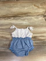 Top view of white and blue bubble romper, size 3M, showing knotted shoulder straps and elasticized waist on wood floor
