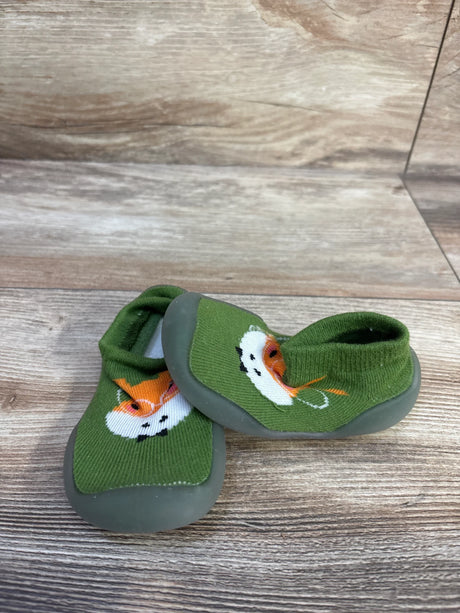 Three-quarter view of Ikevan giraffe knitted sock shoes showcasing green knit with giraffe face and gray rubber soles on wood background