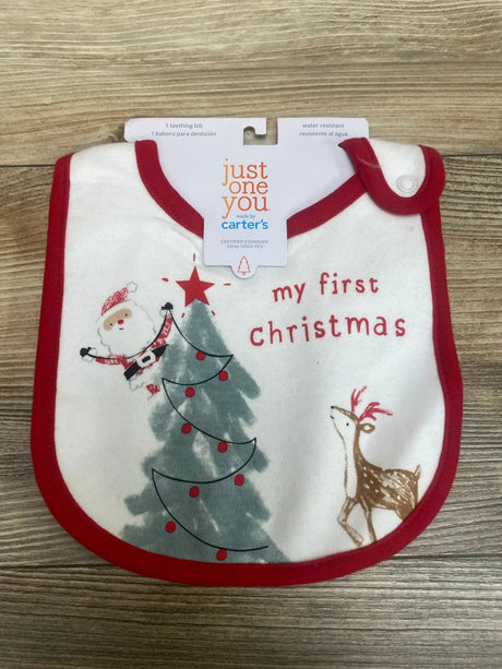 Front view of Just One You My First Christmas bib showcasing Santa, Christmas tree, and reindeer with red trim on a wood background