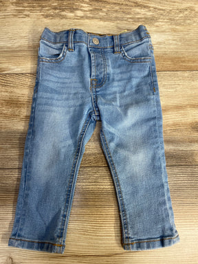 Light blue denim toddler jeans with classic five-pocket design on wooden floor