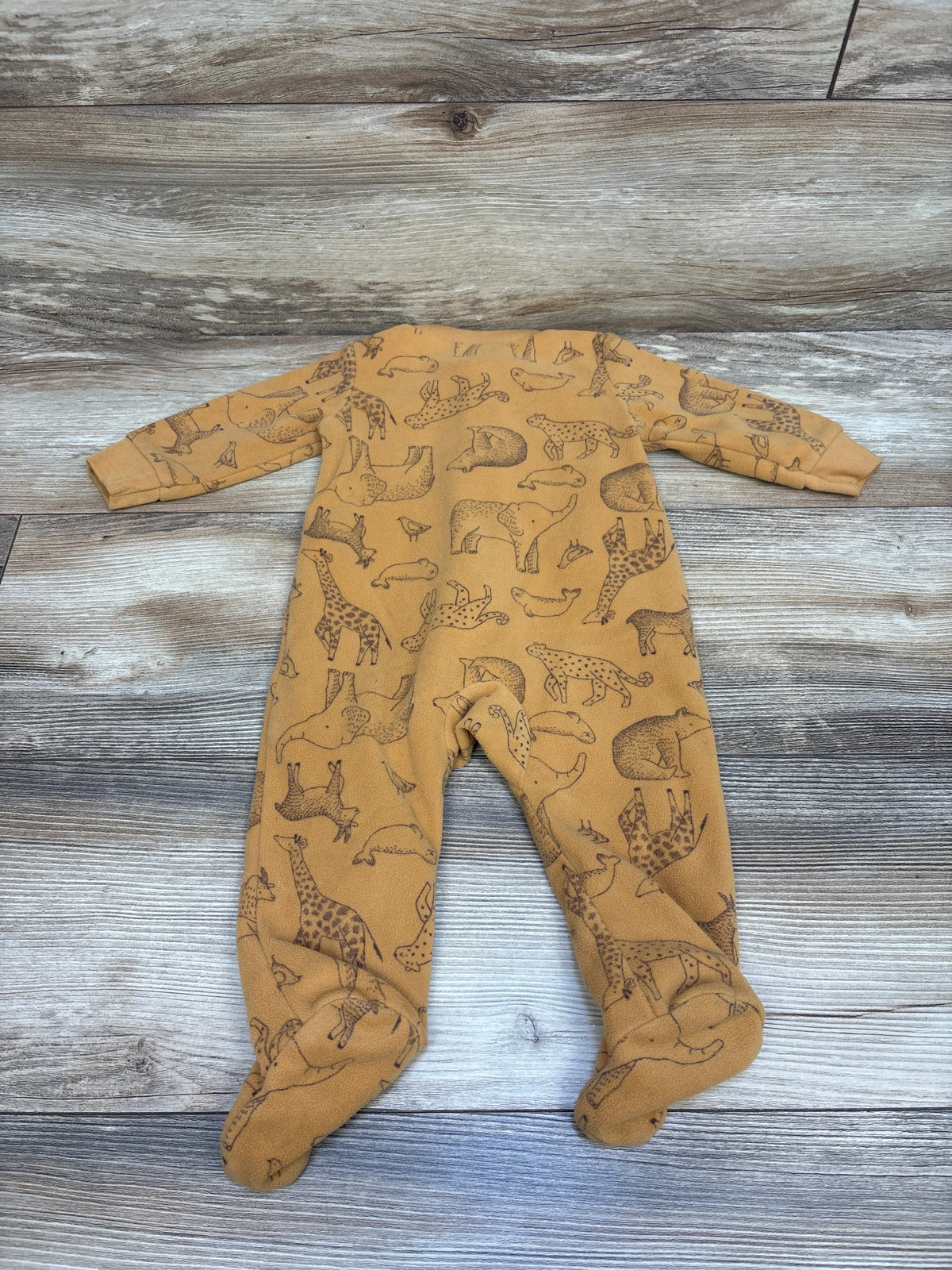 Flat lay of Child Of Mine orange blanket sleeper for three to six months, with long sleeves, covered feet, and animal print