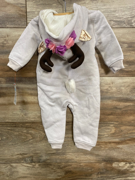 Light gray baby onesie with hood, decorated with antlers, fabric flowers, and a white tail on wooden floor