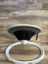 Rear view of Munchkin Bluetooth Enabled Baby Swing with white ring base, gray seat and black mesh back on wood floor