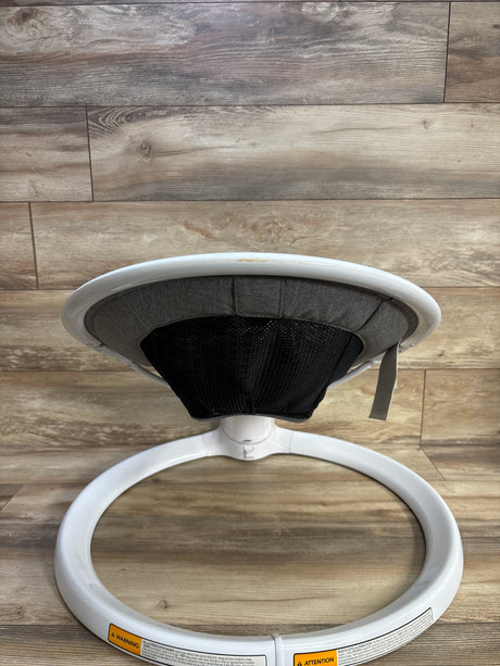 Rear view of Munchkin Bluetooth Enabled Baby Swing with white ring base, gray seat and black mesh back on wood floor