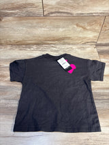 Back view of NEW Cotton On Kids Barbie short sleeve shirt sz 2T showcasing dark grey cotton tee with retail hangtag on wood plank floor