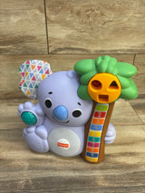 Front of Fisher-Price Linkimals Counting Koala toy with purple koala holding numbered tree and shape-sorter face on wood