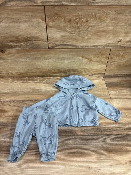 Top view of Carter’s blue newborn 2-piece zip-up jacket and pants set showcasing animal print, hood, and front zipper on a wood surface