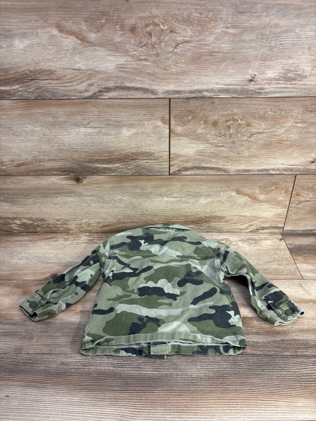 Back view of toddler camo denim jacket size 2T showing green camouflage print, long sleeves and button cuffs on wood plank background