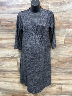 Dark gray textured maternity dress with 3/4 sleeves on black mannequin against wood panel backdrop