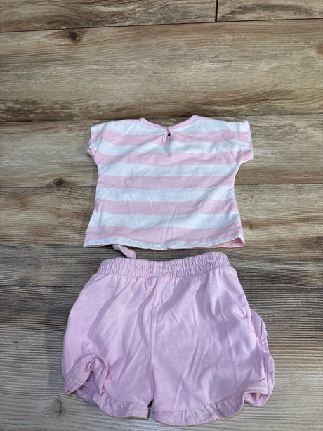 Flat lay of pink and white striped baby tee (back with keyhole button) and matching solid pink elastic-waist shorts on wood