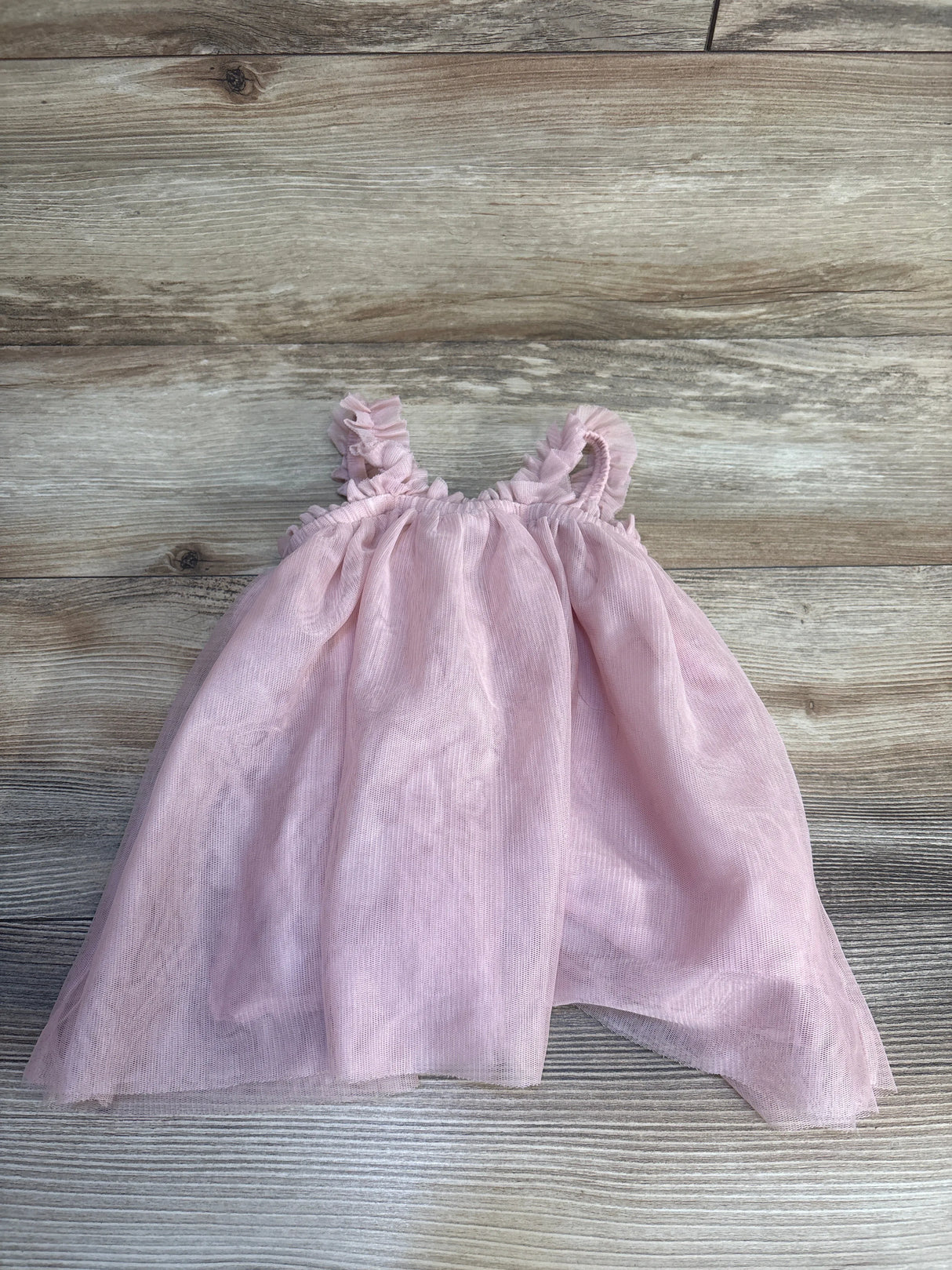 Pink baby dress with ruffled straps and tulle skirt, perfect for infants and toddlers.