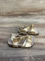 Gold toddler sandals with buckle straps on wooden background, kids footwear resale