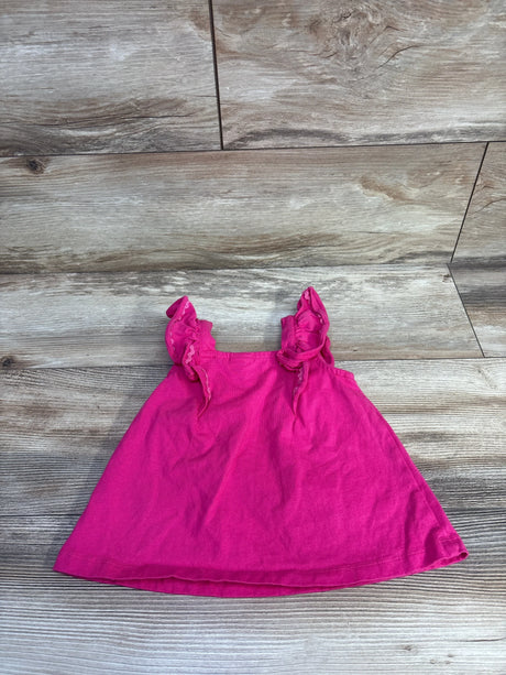 Flat lay of hot pink jersey top size 2T showcasing ruffled shoulder straps on wood plank background