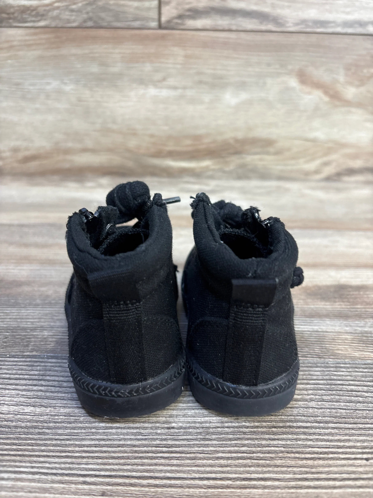 Rear view of Billy Footwear adaptive high-top toddler sneakers showcasing heel pull tabs and back seams with wooden background