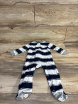 Flat lay of navy and white striped footed sleeper size 6-9 months, back up, gray cuffs and white non-slip foot grips on wood