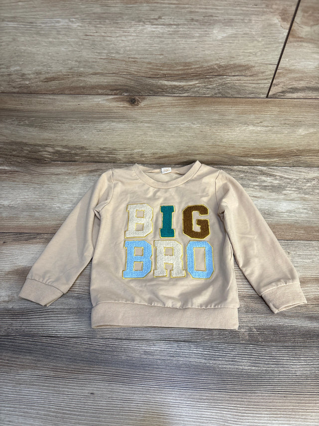 Beige toddler sweatshirt with colorful BIG BRO letters on wood background, kids clothing