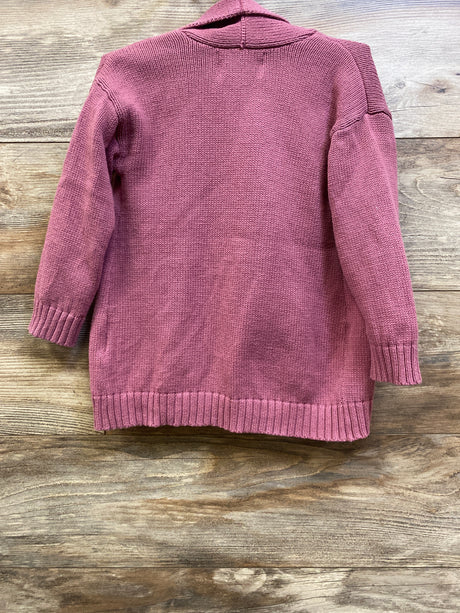 Back view of Old Navy pink open-front cardigan sweater in size 3T showcasing ribbed cuffs and hem with a wood-grain background